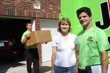 Smiling Junkbusters employee with happy customer